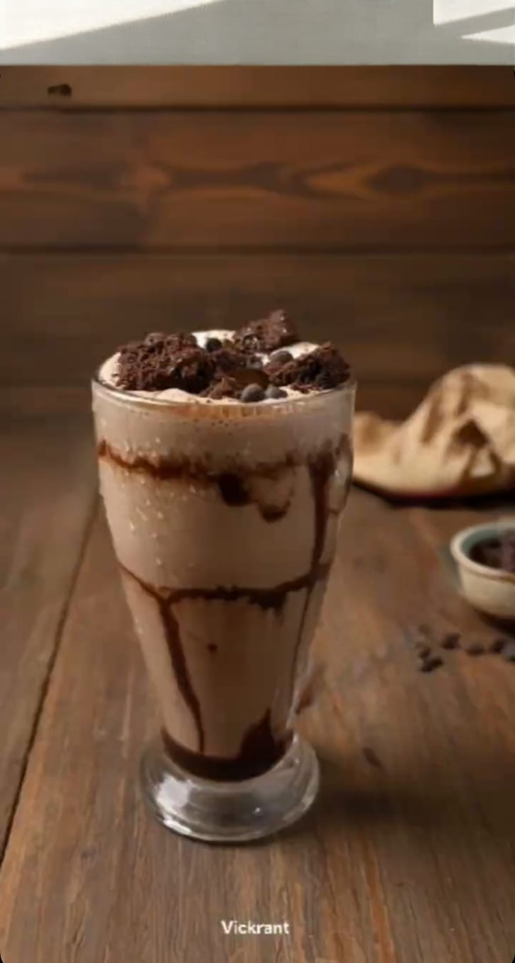 Brownie Mocha Shake at Vistara Cafe topped with whipped cream, chocolate brownie chunks, and rich chocolate drizzle